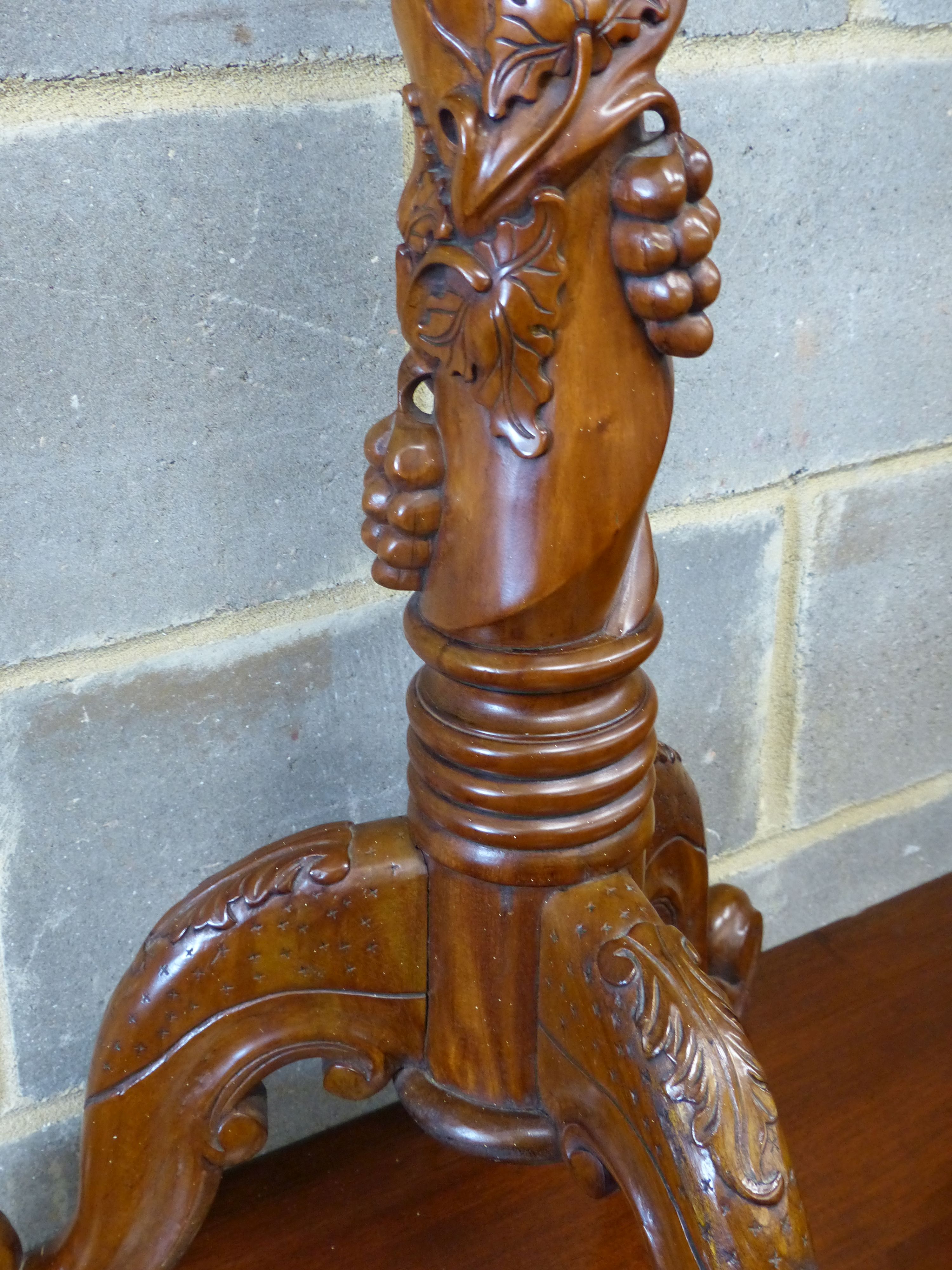 A reproduction carved mahogany torchere, height 114cm